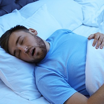 Man with sleep apnea in Henrico snoring in bed