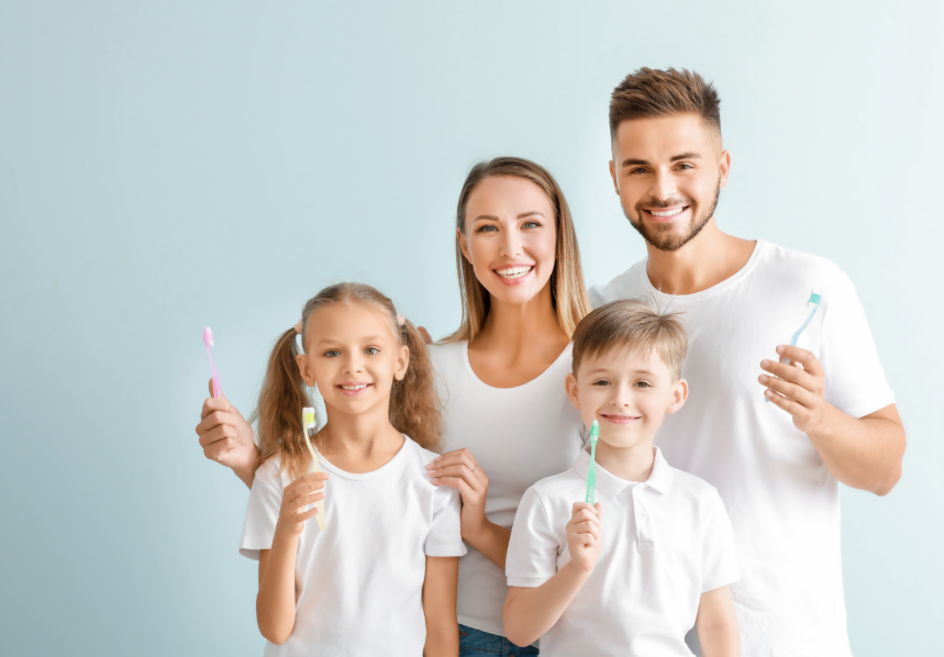 Family holding toothbrushes