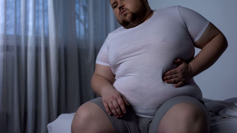 A man in bed with acid reflux